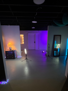 image showing one of the main sections of the creative studio. it features four themed sets, separated by partial walls, each having their own lighting rig.