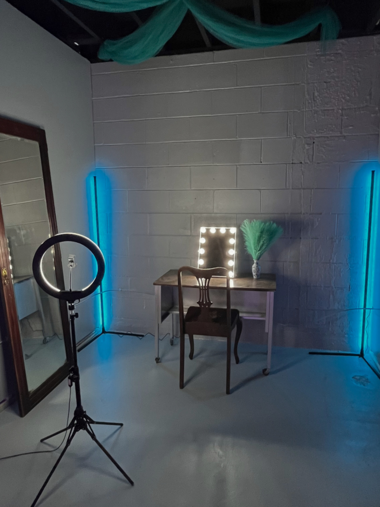 image of the "vanity" themed set. a teal and silver themed self-photography set with a ring light, a makeup vanity, and an LED vanity mirror for makeup tutorials.