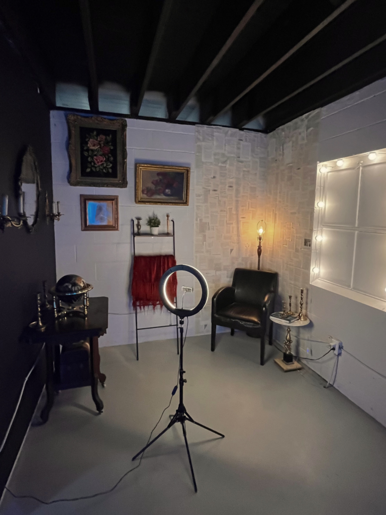 image of the "dark academia" themed self-photography set with a ring light, and DA themed décor for filming talking head YouTube videos.